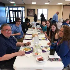 Faith Community Church families sharing a meal together